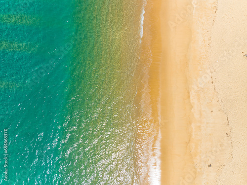 Aerial view of sea crashing waves White foaming waves on beach sand, Top view beach seascape view Nature sea ocean background