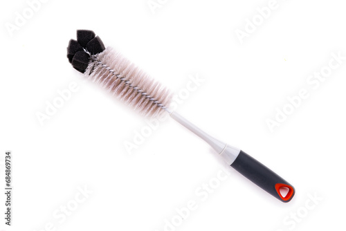 Brush for washing dishes and bottles made of environmentally friendly plastic. Isolated on a white background.