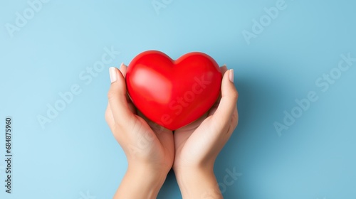 Heart held by woman s hands on colorful background. World health day