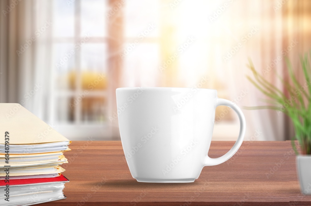 coffee cup on desk, note book by window coffee cup on desk, note book by window