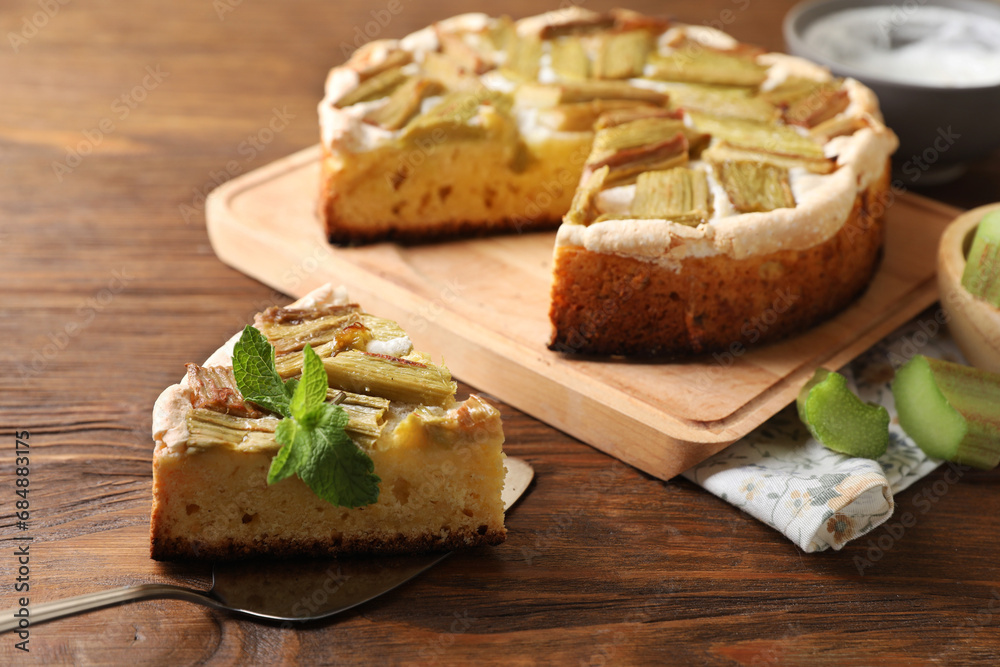 Freshly baked rhubarb pie and cake server on wooden table Freshly baked rhubarb pie and cake server on wooden table