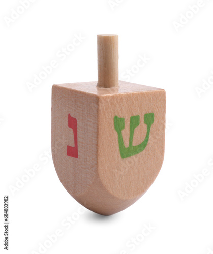 Wooden dreidel isolated on white. Traditional Hanukkah game photo