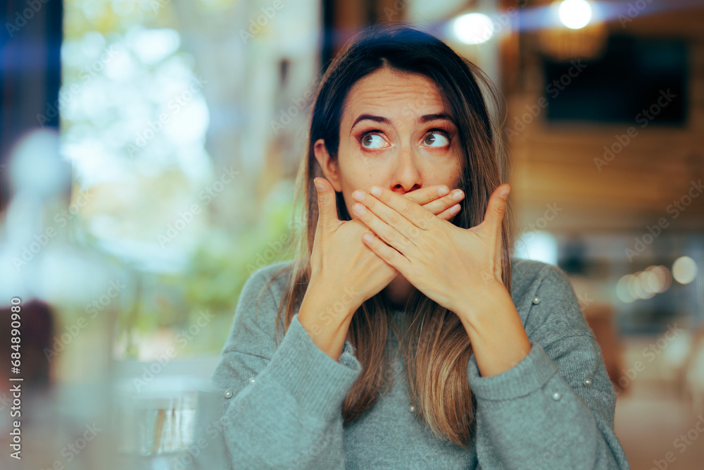 Burping Woman Covering her Mouth in a Restaurant. Sick girl feeling nauseated and gassy after her meal 
 - obrazy, fototapety, plakaty 