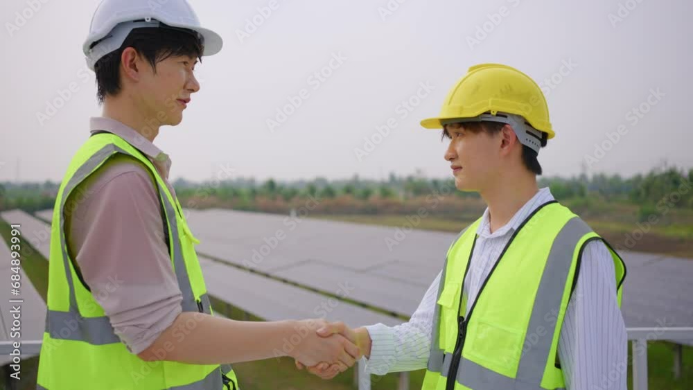 Young engineer making handshake, work with photovoltaic panel system. Young engineer making handshake, work with photovoltaic panel system.