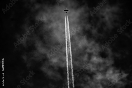 Airplane flying in the blue sky with white clouds in the background