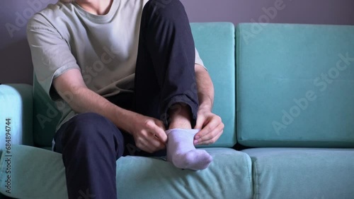 person holding a sock and put it on in the morning