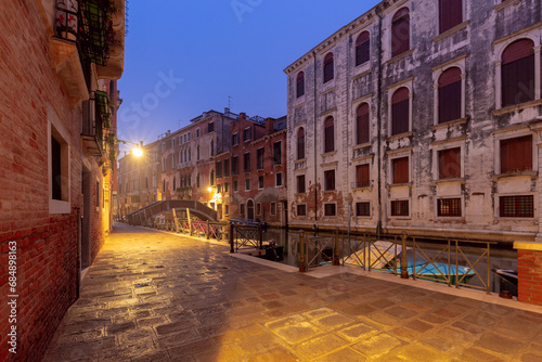 Traditional Venetian houses along the canal on a sunny day. © pillerss
