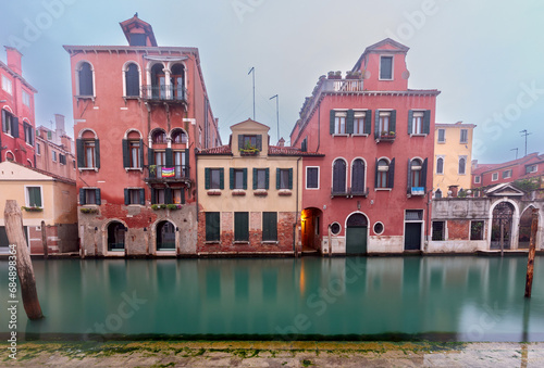 Traditional Venetian houses along the canal on a sunny day.