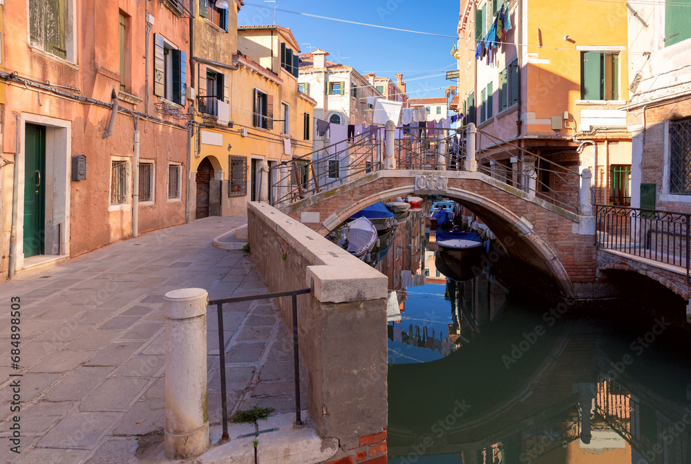 Traditional Venetian houses along the canal on a sunny day.