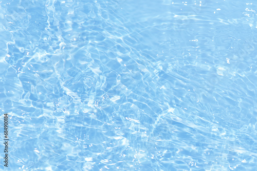 Bluewater bubbles on the surface ripples. Defocus blurred transparent white-black colored clear calm water surface texture with splash and bubbles. Water waves with shining pattern texture background.