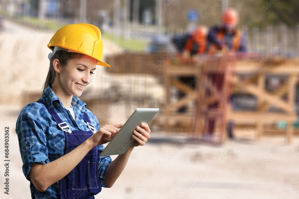 Fototapeta premium Portrait of young cvil engineer at work on construction site