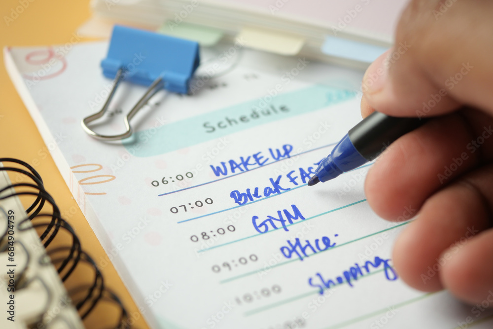 writing on a daily planner on table. writing on a daily planner on table.