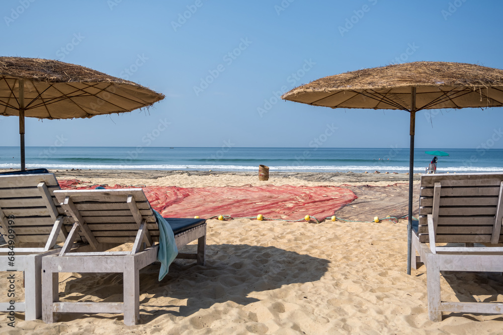 wooden beach umbrellas and sunbeds loungers on sandy beach of ocean wooden beach umbrellas and sunbeds loungers on sandy beach of ocean