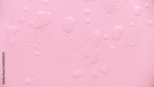Water drops over a pink background for creative poster design.