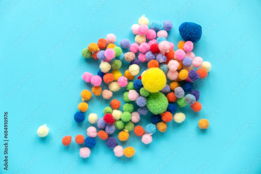 Colorful pom pom cotton ball isolated on blue background. For montessori. Colorful pom pom cotton ball isolated on blue background. For montessori.