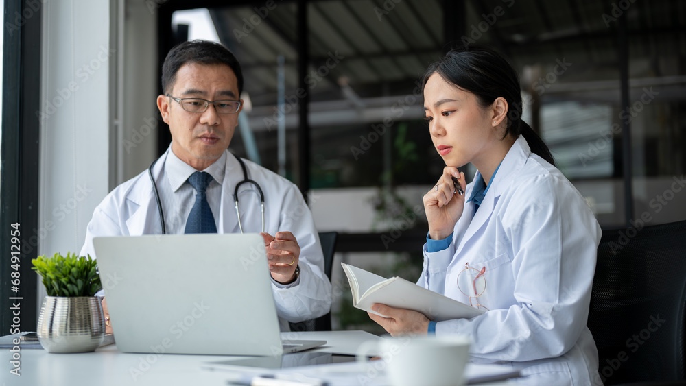 Young female doctor is asking for advice from a professional senior male doctor in the office room. Young female doctor is asking for advice from a professional senior male doctor in the office room.
