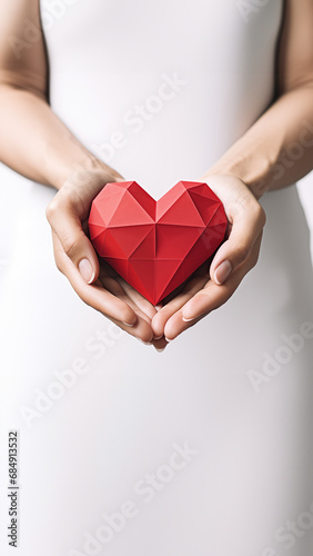 Female holding red heart shape polygonal paper . Valentine s Day  love  holiday  healthcare  medical  health and medicine concept with copy space for text