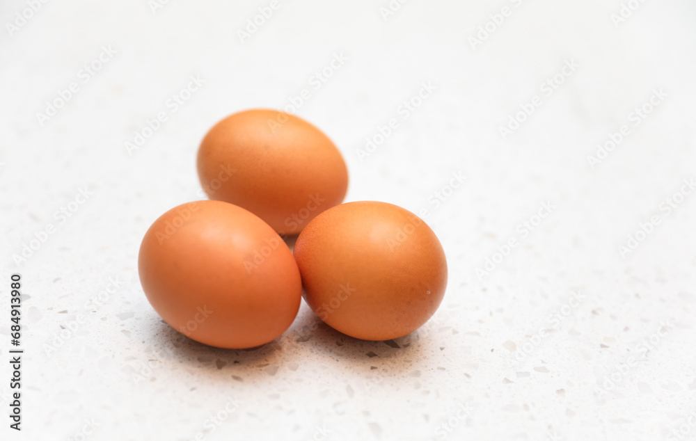 brown eggs in a rustic basket on wooden table, natural light, farm-fresh concept