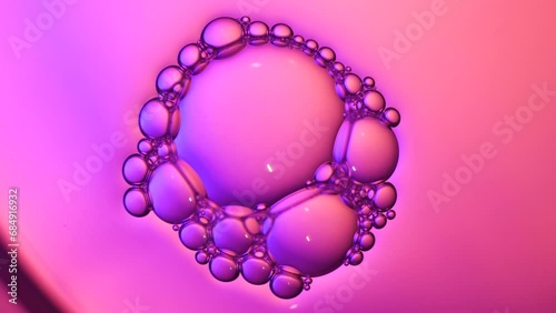 Top view pink soap bubbles floating on the water, color light background