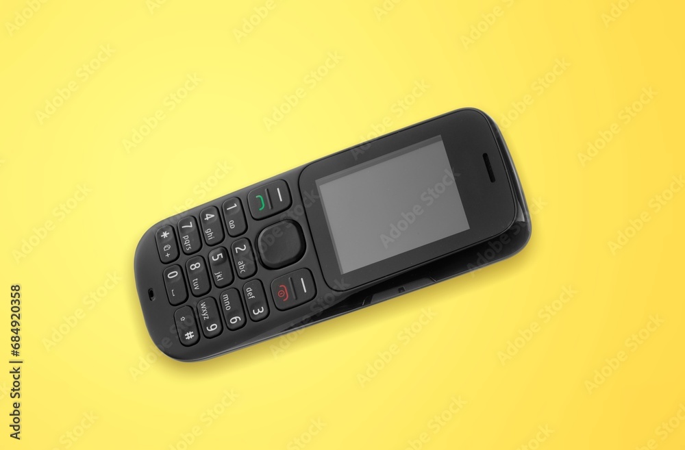 old retro mobile phone on yellow background. old retro mobile phone on yellow background.
