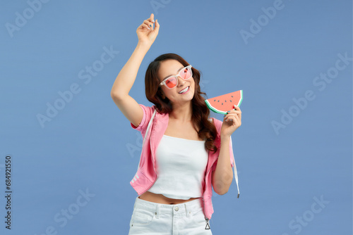 Beautiful young woman posing with watermelon on color background