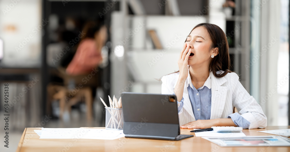 Tired sleepy woman yawning, working at office desk, overwork and sleep deprivation concept Tired sleepy woman yawning, working at office desk, overwork and sleep deprivation concept
