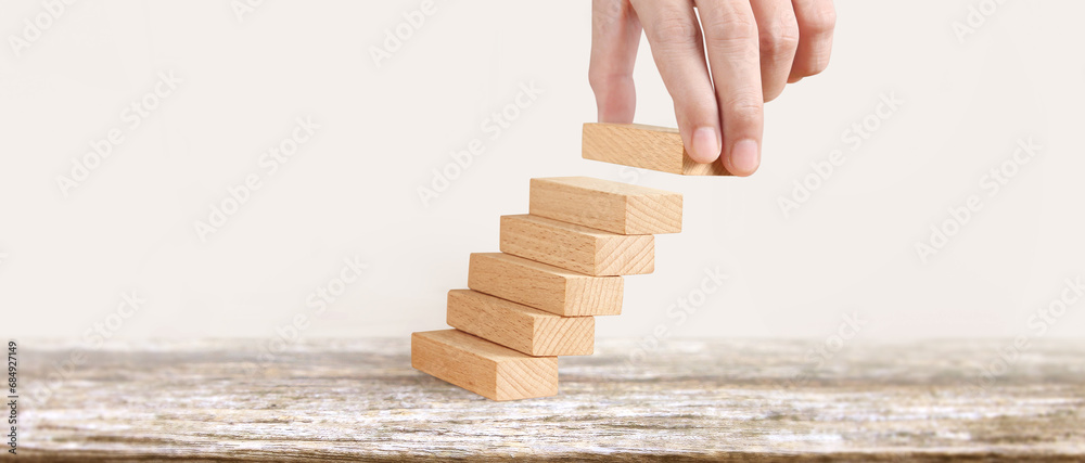 Hand liken business person stepping up  toy staircase - obrazy, fototapety, plakaty 