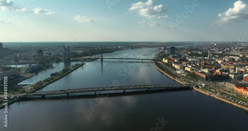 Aerial panoramic shot featuring Riga's Vansu bridge over Daugava river, near dome cathedral, St. Gertrude church, Three Brothers, oldtown. Beautiful 4k prores video in daylight of Latvia capital city. photo
