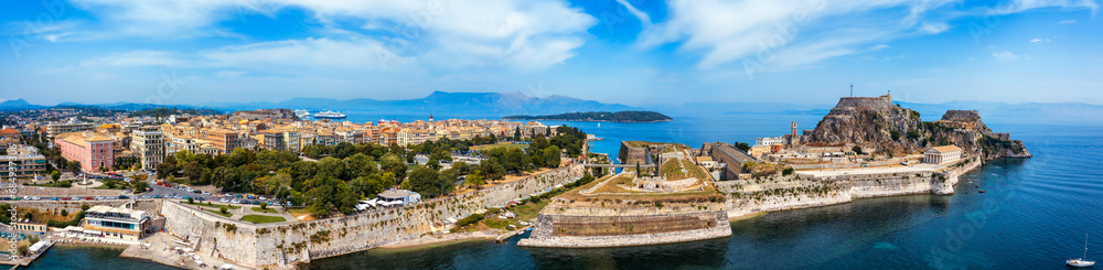 Obraz premium Panoramic view of Kerkyra, capital of Corfu island, Greece. Aerial drone view of Kerkyra with beautiful buildings during summer sunny day. Corfu island, Greece.