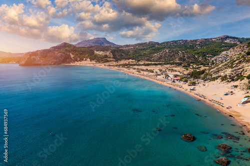 Tsampika beach with golden sand view from above, Rhodes, Greece. Aerial birds eye view of famous beach of Tsampika, Rhodes island, Dodecanese, Greece