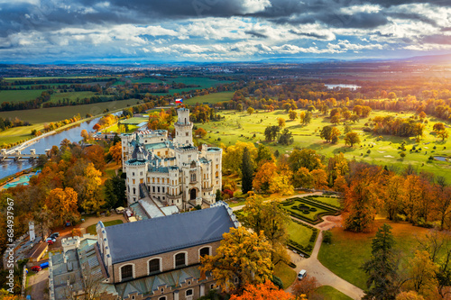 Castle Hluboka nad Vltavou is one of the most beautiful castles in Czech Republic. Castle Hluboka nad Vltavou in autumn with red foliage, Czechia. Colorful autumn view of Hluboka nad Vltavou castle.