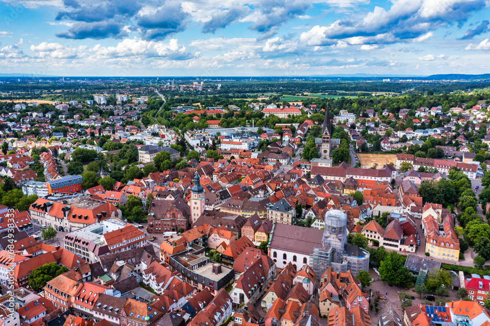 Naklejka premium Old city of Ettlingen in Germany with a river and a church. View of a central district of Ettlingen, Germany, with a river and a bell tower of a church. Ettlingen, Baden Wurttemberg, Germany.