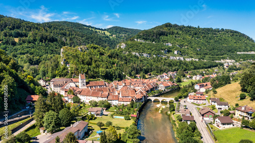 Picturesque Swiss village of Saint-Ursanne on the Doubs River, Switzerland. Village Saint-Ursanne in the district of Porrentruy in the canton of Jura, Switzerland. Saint Ursanne, Jura, Suisse photo