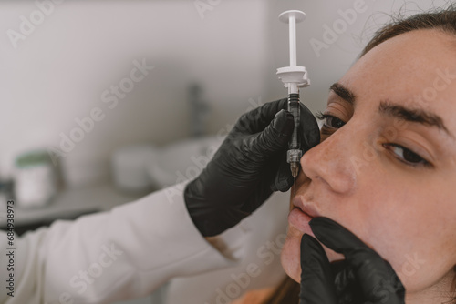 Doctor filling the lips of a patient with Botox