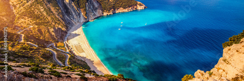 Aerial drone view of iconic turquoise and sapphire bay and beach of Myrtos, Kefalonia (Cephalonia) island, Ionian, Greece. Myrtos beach, Kefalonia island, Greece. Beautiful view of Myrtos beach. photo
