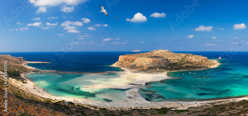 Balos Lagoon and Gramvousa island on Crete with seagulls flying over, Greece. Cap tigani in the center. Balos beach on Crete island, Greece. Crystal clear water of Balos beach. photo