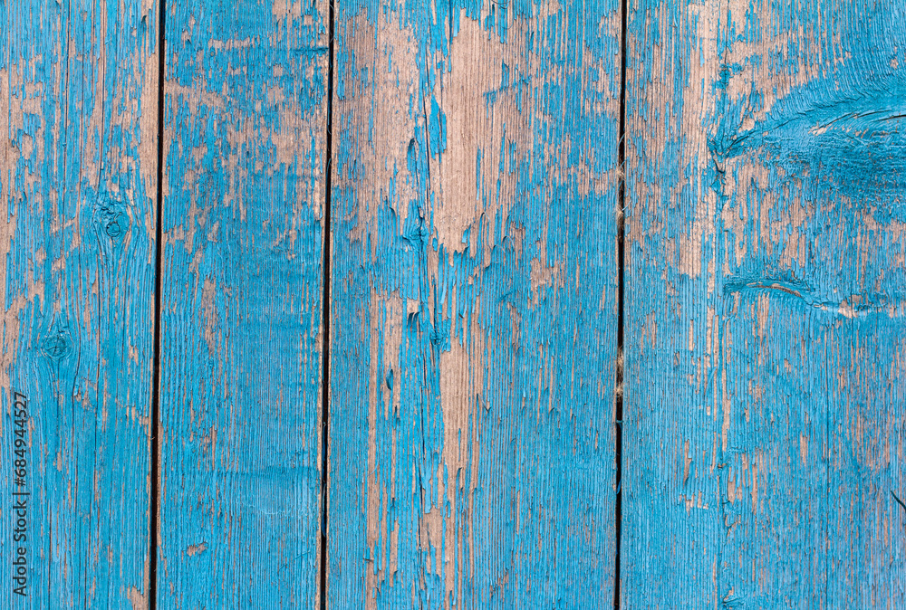 old wooden wall painted blue, weathered wooden background with nails and slits. old wooden wall painted blue, weathered wooden background with nails and slits.