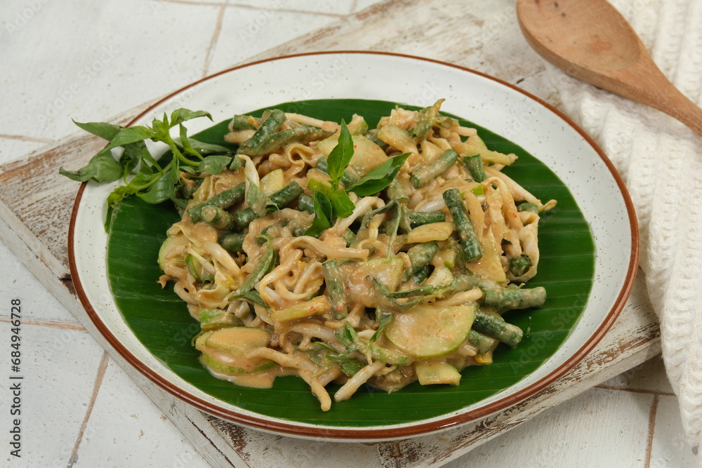 Karedok or keredok is raw vegetables salad covered in spicy peanut