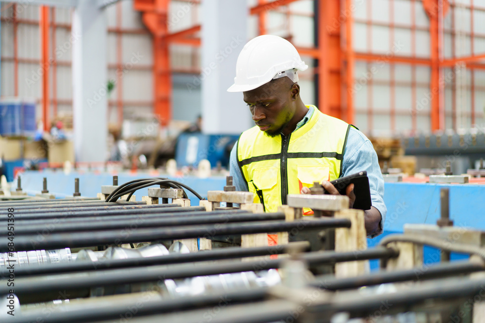 American - African worker inspecting machine in factory, machanical engineer working on machines in factory. American - African worker inspecting machine in factory, machanical engineer working on machines in factory.