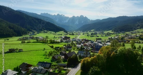 Beautiful aerial view of Gosau municipality in Austria. Small villages and asphalt road visible in a saturated green fields between mountains. High quality 4k prores footage. photo