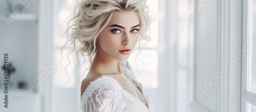 In a luxurious white interior, a beautiful woman, with sexy lines and stunning lace attire, poses for a portrait showcasing her fashionable girl's makeup and perfectly styled hair, highlighting her