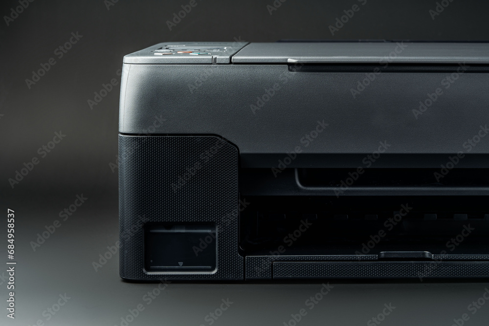 Modern laser printer on black background close up Modern laser printer on black background close up