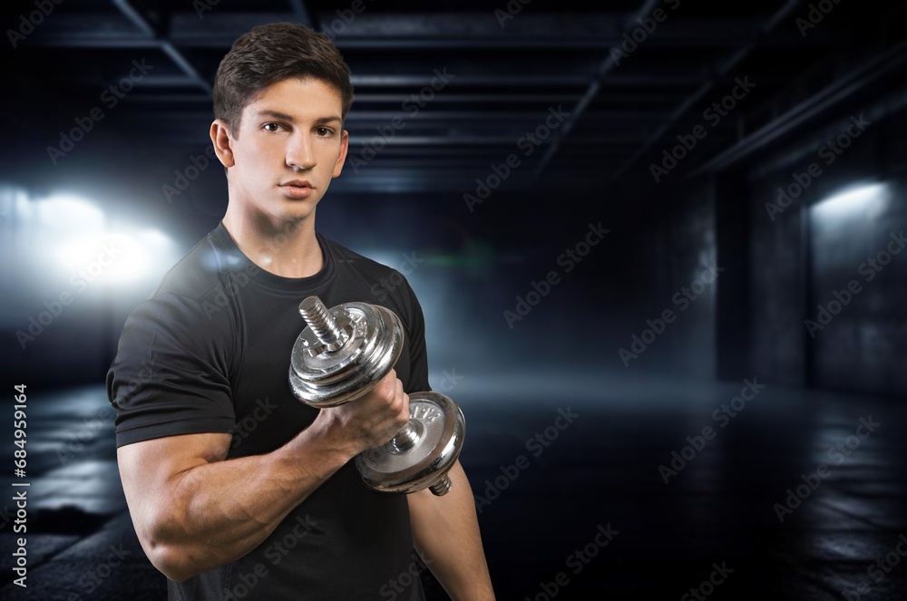 Young sporty man workout training biceps with dumbbell Young sporty man workout training biceps with dumbbell