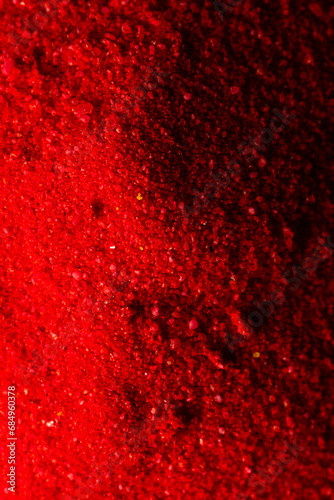 Vertical image of close up of red powder with copy space background
