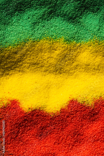 Vertical image of green, yellow and red powders with copy space background