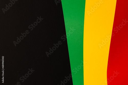 Green, yellow and red papers with copy space on black background