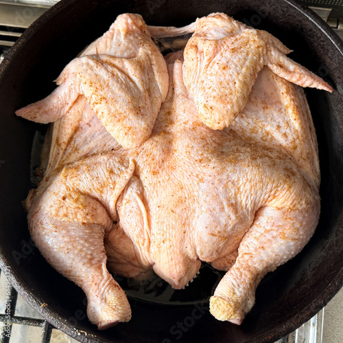 Chicken is fried in a frying pan