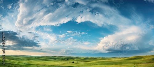 From the open prairie to the dramatic skies above  the summer landscape unfolds  revealing a beautiful and natural scenery  with clouds forming a dramatic cloudscape as the weather turns stormy