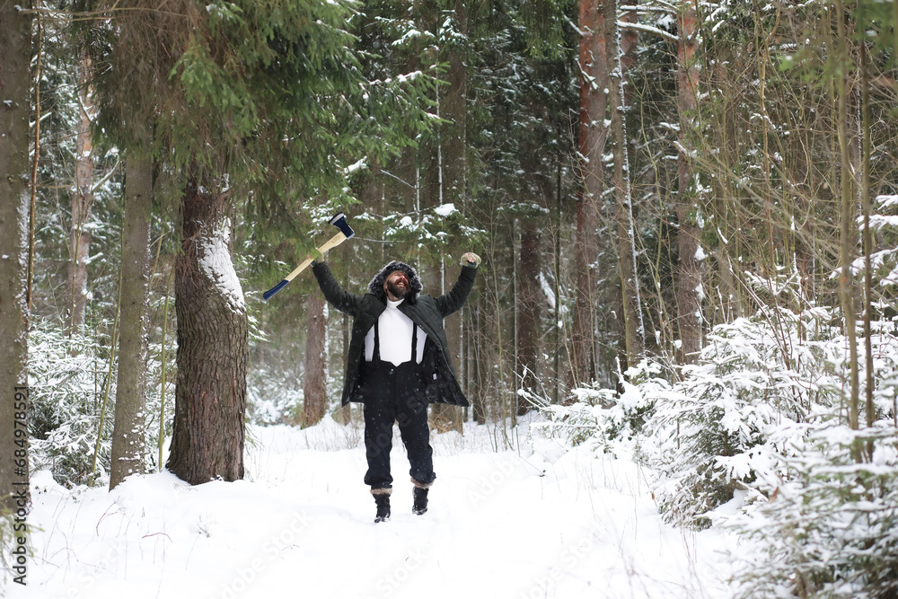 Outdoor portrait of handsome man in coat and scurf. Bearded man in the winter woods. Outdoor portrait of handsome man in coat and scurf. Bearded man in the winter woods.