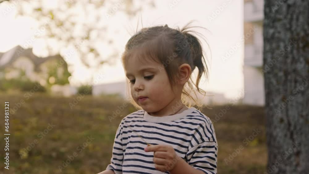 Adorable little girl playing in autumn park. Cute child having fun outdoors. Adorable little girl playing in autumn park. Cute child having fun outdoors.